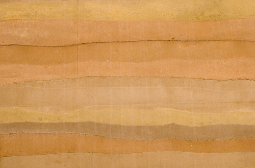 The striations, natural earthtone colors, and textures of a rammed earth wall, the latest ecological building material. Source: Shutterstock