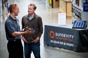 SOLAR HOME IMPROVEMENT  A Sungevity salesman educates a Lowe’s customer about solar inside a store. Sungevity has been working with Lowe’s stores across multiple states since 2011. Photos courtesy of Sungevity. 