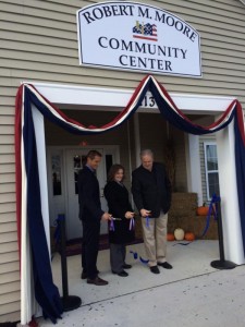Tom Pollock, Matt Haydinger, and Anita Moore cut the ribbon on the solar electric system at United Communities, Joint Base McGuire-Dix-Lakehurst while dedicating the community center Robert M. Moore. 