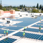 Workers install solar panels on the roof of a Mountain View, CA Walmart store. Photo credit: Walmart/Flickr Creative Commons