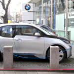 A BMW i3 electric car gets a charge. The vehicle is a hot new model expected to sell well, but the EV market can only reach its potential with expanded charging and consumer awareness, along with the easing of range anxiety. Photo credit: Kārlis Dambrāns/Flickr Creative Commons