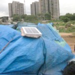 A new customer hangs his micro panel on top of his shelter in India. Photo credit: Ted Swagerty