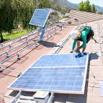 Workers install solar panels on the roof of a house in Oak View, Southern California. Photo courtesy of Shutterstock